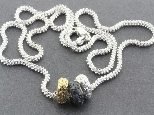 Tubular volcanic pendant - silver, gold & oxidized on 55cm chain