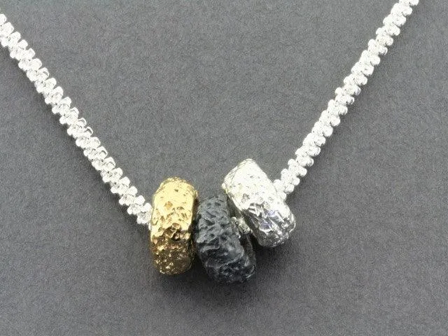 Tubular volcanic pendant - silver, gold & oxidized on 55cm chain