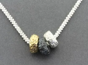 Tubular volcanic pendant - silver, gold & oxidized on 55cm chain