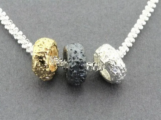 Tubular volcanic pendant - silver, gold & oxidized on 55cm chain